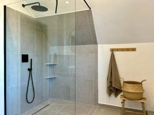 a shower with a glass door in a bathroom at Ferienwohnung Smukke Bleibe in Maasholm