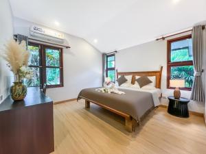 Postel nebo postele na pokoji v ubytování begonia N7 villa resort海棠7号别墅酒店 + 37 fotografií