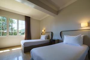 Cama o camas de una habitación en Crisol Jardines de Córdoba