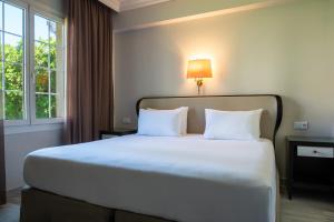 Cama o camas de una habitación en Crisol Jardines de Córdoba