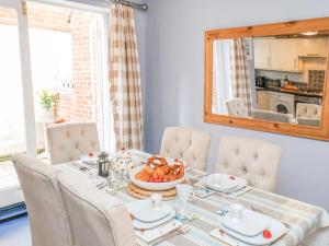 a dining room with a table with a bowl of fruit at Adventure Cottage in Whitby