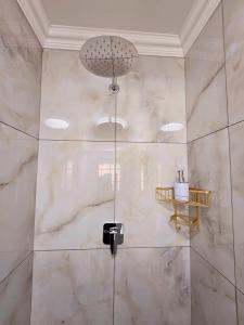 a bathroom with a shower with a glass door at Hampton Collection Avenues - Cosy 2 Sleeper Studio Apartment in Durban