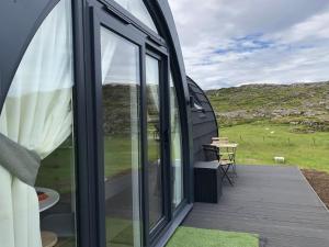 a view from the outside of a house with a deck at Sandy Meadow Escapes in Lairg
