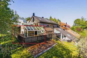 an aerial view of a house with a yard at 7 min to Ski Championship, Glass front house, Terrace in Trondheim +7 photos