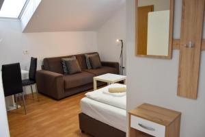 a living room with a couch and a table at Apartments Park Vodice - Ljubljana, Krvavec in Woditz