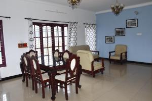 a dining room with a table and chairs at Elk Hill Palace in Ooty