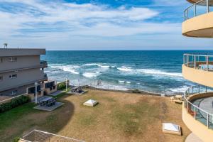 a view of the ocean from the balcony of a building at Bermuda 302 in Ballito