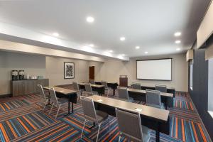 a conference room with tables and chairs and a screen at Hampton Inn & Suites Harrisburg in Harrisburg +33 photos