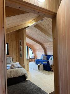 a room with a bed and a couch in a room at Sandy Meadow Escapes in Lairg