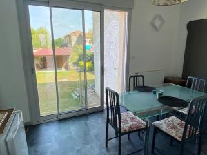 a dining room with a glass table and chairs at Grand T2 indépendant centre ville 1er étage in Saint-Junien
