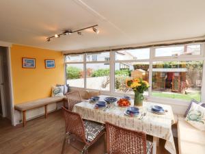 a dining room with a table and chairs at Seacliff Cottage in Whitby