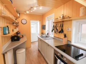 a kitchen with a sink and a counter top at Seacliff Cottage in Whitby +25 photos