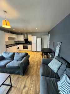 a living room with two couches and a kitchen at Private room - Shared Bathroom, Wakefield in Wakefield +14 photos