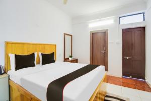 Postel nebo postele na pokoji v ubytování Collection O Bay + 28 fotografií
