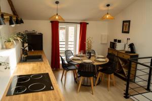a kitchen and dining room with a table and chairs at La Halte de la tour in Warcq +20 photos