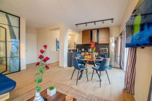 a living room and kitchen with a table and chairs at Two Bedroom Apartment, Spacious & Newly Renovated, Three Minutes from the Beach in Limassol +15 photos