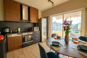 a kitchen with a wooden table and a dining room at Two Bedroom Apartment, Spacious & Newly Renovated, Three Minutes from the Beach in Limassol