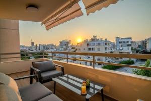 a balcony with a view of a city at Two Bedroom Apartment, Spacious & Newly Renovated, Three Minutes from the Beach in Limassol