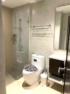 a bathroom with a toilet and a glass shower at Emerald Terrace Condo 5-Studio Garden zen in Patong Beach