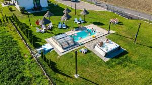 an overhead view of a swimming pool with people in it at Słoneczne Wzgórze Zator in Zator