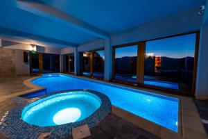 a large swimming pool in the middle of a house at The View - Lake Resort & Spa in Rugineşti