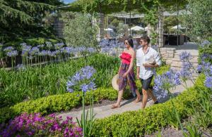 a man and a woman walking through a garden at Bluesun Hotel Borak in Bol