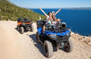 two people riding atvs on a dirt road at Bluesun Hotel Borak in Bol