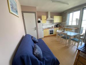 een woonkamer met een blauwe bank in een keuken bij Ty Fanch Quiberon in Quiberon