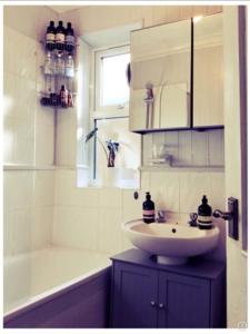 un bagno con un lavandino, una vasca da bagno e un lavandino di Lovely place a Londra