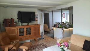 a living room with a flat screen tv and a couch at Bed and Breakfast Filskov in Filskov