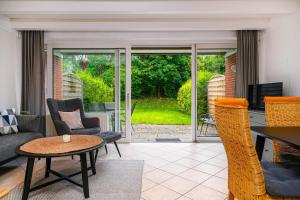 a living room with a couch and a table at Ferienhaus Heimathafen in Bensersiel +28 photos