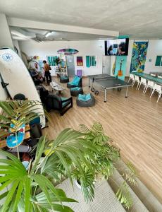 a room with a ping pong table in a room with plants at Medano Nest Hostel in El Médano +18 photos