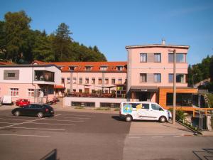 a car parked in a parking lot next to a building at Hotel Fabrica in Liberec