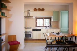 a kitchen with a table and a dining room at Trullo Casa Surya in Martina Franca