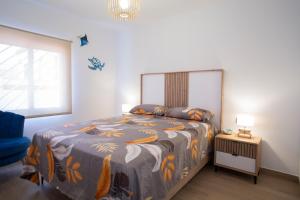 a bedroom with a bed with a colorful comforter at La Palapa Beach in Benalmadena Costa +28 photos