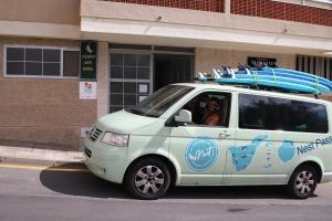 a van with a surfboard on top of it at Medano Nest Hostel in El Médano