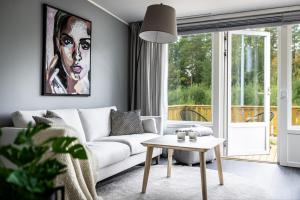 a living room with a white couch and a table at Private Chalet in Skellefteå