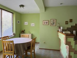 a dining room with a table and chairs at Одеса 37 in Sozopol