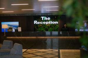 a reception desk with a sign that says the reception at Apartament Silver Mountain Resort & Spa Poiana Brasov in Poiana Brasov
