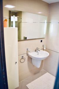 a bathroom with a sink and a mirror at Apartament Silver Mountain Resort & Spa Poiana Brasov in Poiana Brasov +21 photos