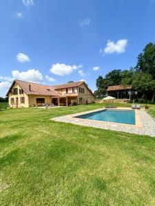a house with a swimming pool in the yard at Maison Puchouaou Gîte 8 ou 12 personnes avec piscine privée in Montesquiou