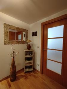a room with a door and a vase with flowers in it at Acogedor Apartamento En Huesca in Huesca