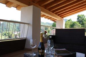 a table with two glasses and a bottle of wine at Sette Fiori Luxury Apartments in Miane Premaor +44 photos