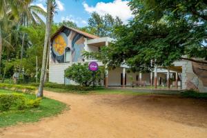 a house with a painting on the side of it at Olive Farm @ Embassy International Riding School in Yelahanka