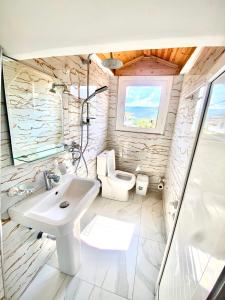 a bathroom with a sink and a toilet at Guest House Rean in Berat +26 photos