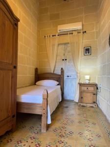 Postel nebo postele na pokoji v ubytování Ta Speranza Farmhouse B&B