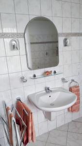 a bathroom with a sink and a mirror and towels at Mama Mia in Süssau +12 photos