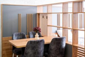 a dining room with a wooden table and chairs at Mountain Magic Bjelašnica in Bjelašnica +95 photos