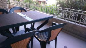 a black table and chairs on a balcony at Одеса 37 in Sozopol