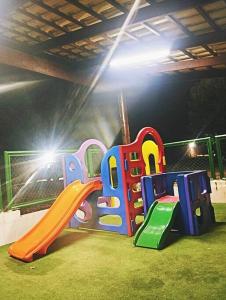 a childrens playground with a slide in a room at Thermas place 406 in Caldas Novas
